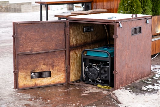 Portable electric generator running in the cold winter.Energy genocide. Power outage as a result of missile strikes by Russia on energy facilities of Ukraine. Small business use gasoline generators. photo