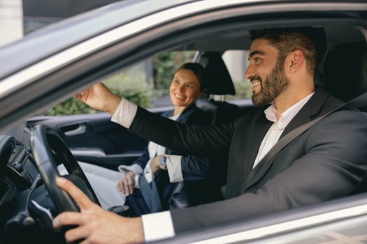 Cheerful couple of business colleagues going on a business trip together and having some fun photo