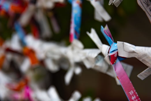 A fortune telling slip at Tomioka Shrine closeup photo