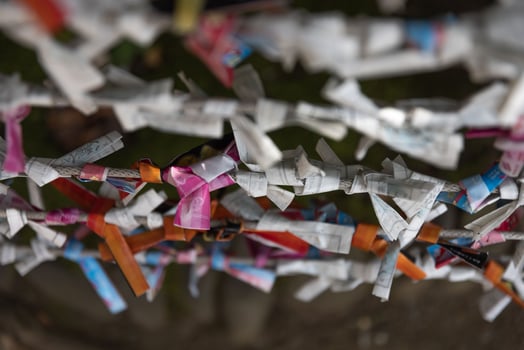 A fortune telling slip at Tomioka Shrine closeup photo