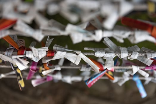 A fortune telling slip at Tomioka Shrine closeup photo