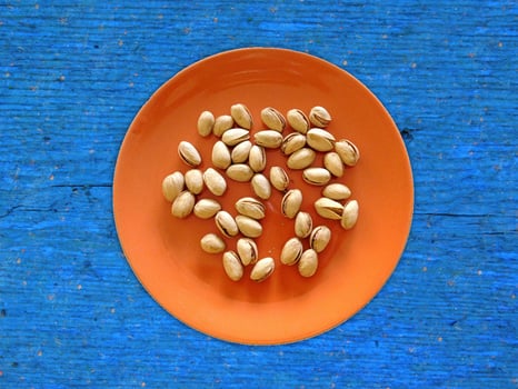 Pistachios On The Wooden Background photo