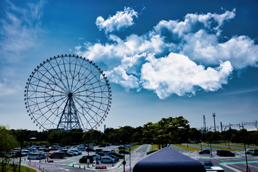 A ferris wheel at the park behind the blue sky wide shot photo