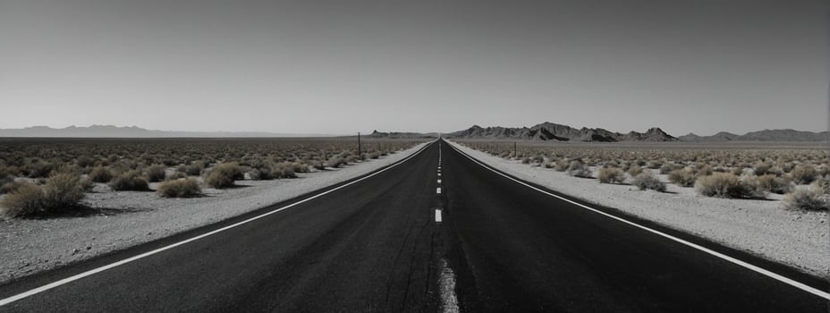 A black and white photo of an empty road