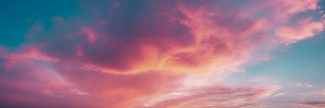 A pink and blue sky with clouds photo