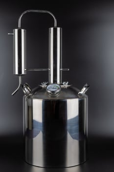 brand new stainless steel alcohol machine on black background photo