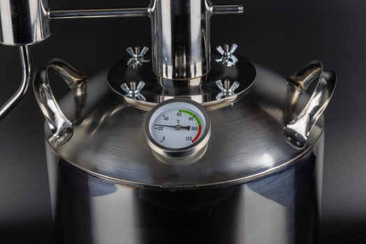brand new stainless steel alcohol machine on black background photo