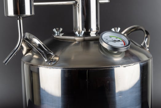 brand new stainless steel alcohol machine on black background photo
