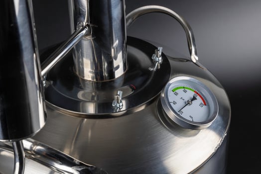 brand new stainless steel alcohol machine on black background photo
