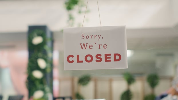 Sorry we are closed sign in empty fancy fashion boutique with stylish formal clothes. Message on designer clothing men premium showroom door announcing customers that shop is closed photo