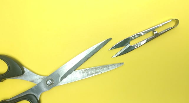Old sewing scissors on a yellow background. View from above. Copy space. photo