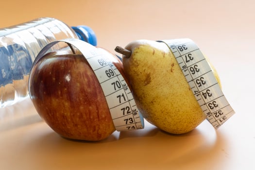 Apple and pear fruits representing forms of obesity photo