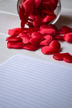 A lot of red symbols of love on the table. Love hearts. photo