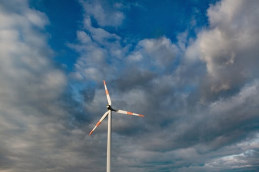 Wind turbine on the background of the blue sky. Clean renewable energy. Electric power production. photo