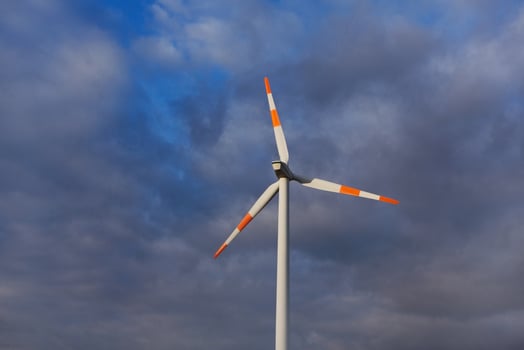 Wind turbine on the background of the blue sky. Clean renewable energy. Electric power production. photo