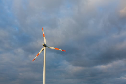 Wind turbine on the background of the blue sky. Clean renewable energy. Electric power production. photo