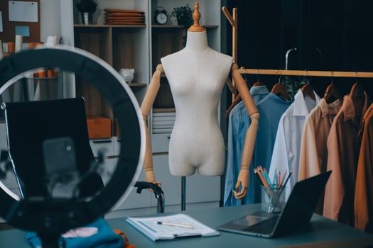Beautiful asian woman blogger showing bag in front of camera to recording vlog video live streaming at her shop.Business online influencer on social media concept. photo