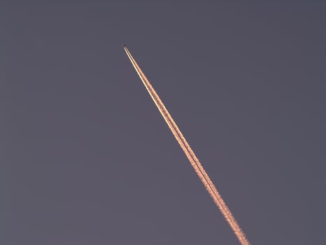 Vapor Trail Behind Jet Climbing Up Into Sky Contrails photo