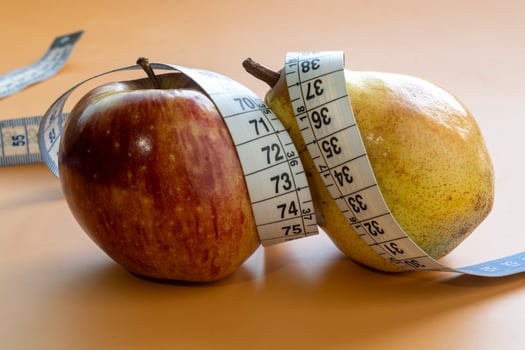Apple and pear fruits representing forms of obesity photo