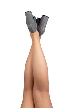 Female legs up, crossed pose, position, wearing gray heeled shoes isolated on white, back view photo
