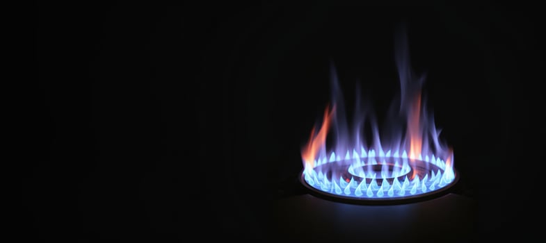 blue flame of a gas burner on a black background banner photo
