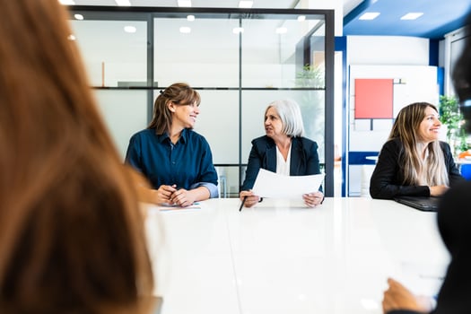 Business women doing a briefing in boardroom of modern office - Brainstorming and teamwork concept photo
