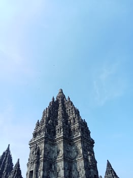 Prambanan temple with bright blue clouds photo