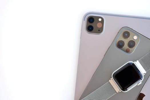 KYIV, UKRAINE - 4 MAY, 2023 Apple brand devices iphone, ipad with apple watch lies on macbook body photo