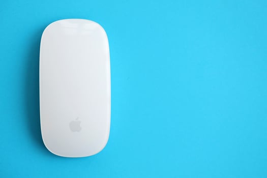 KYIV, UKRAINE - NOVEMBER 27, 2023 Apple Magic Mouse 3rd generation lies on bright colored background photo