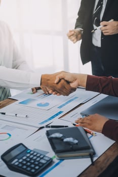 Real estate agent and customers shaking hands together celebrating finished contract after about home insurance and investment loan, handshake and successful deal. photo