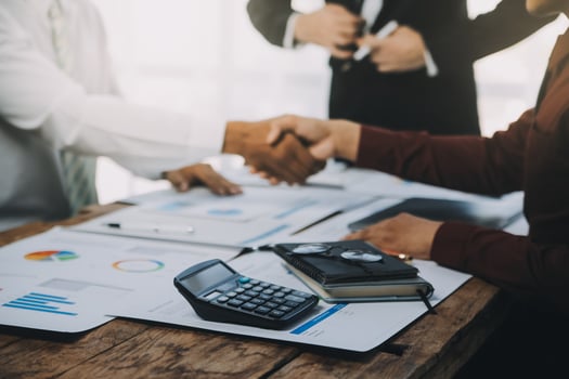 Real estate agent and customers shaking hands together celebrating finished contract after about home insurance and investment loan, handshake and successful deal. photo