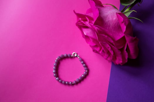 The hand bracelet with decor on pink background. photo