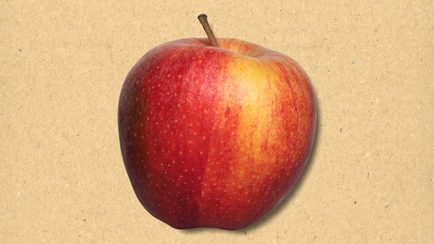 red apple fruit over paper photo