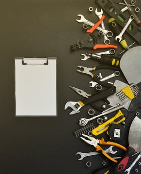 Handyman tool kit on black wooden table. Many wrenches and screwdrivers, pilers and other tools for any types of repair or construction works. Repairman tools photo