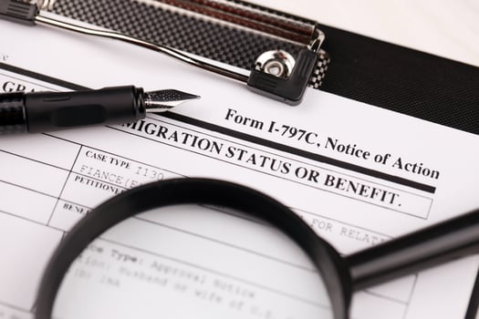 I-797c Notice of action blank form on A4 tablet lies on office table with pen and magnifying glass photo
