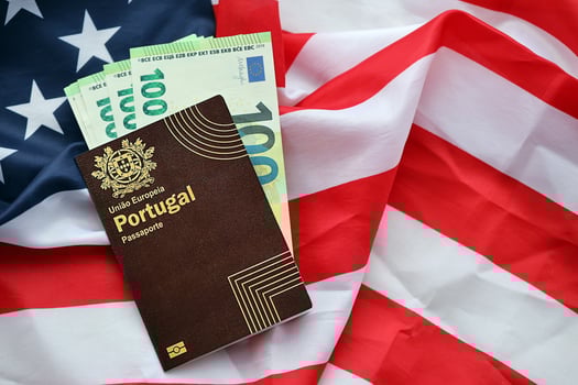 Red Portugal passport of European Union and money on United States national flag background photo