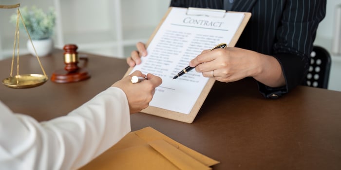 Contract of sale was on the table in the lawyer office the company hired the lawyer office as a legal advisor and draft the contract so that the client could signs the right contract photo