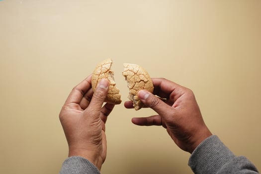 top view of hand breaking sweet cookies photo