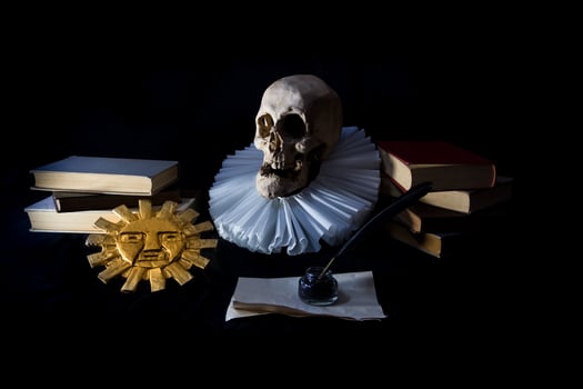 Books with a human skull, a ruff and the Inca sun, symbols of universal literature. Day of the book photo