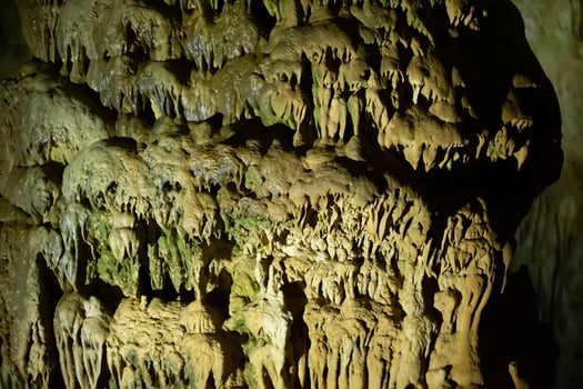 The cave is karst, amazing view of stalactites and stalagnites illuminated by bright light, a beautiful natural attraction in a tourist place. photo