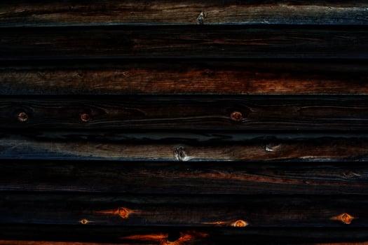 Dark wooden background almost black. Burnt wooden surface. photo