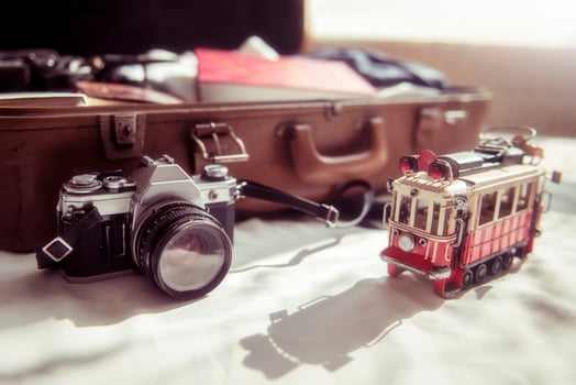 SLR 35mm vintage camera and travel bag in bed room. Preparing for traveling photo