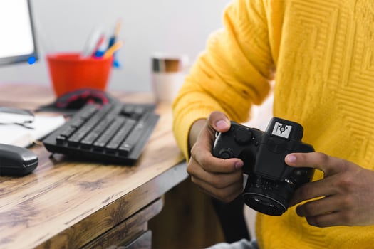 unrecognizable person holding a camera with hands. photo