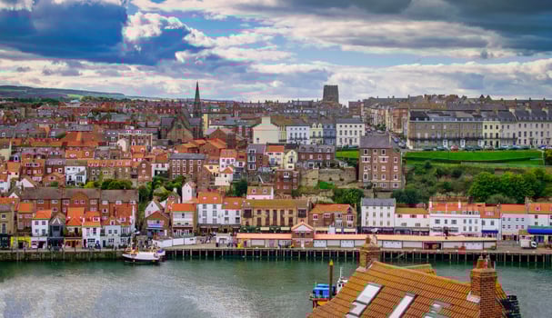 Whitby abbey is a seaside town and port at daytime in North Yorkshire, UK photo