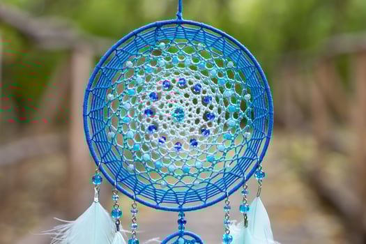 Handmade dream catcher with feathers threads and beads rope hanging photo