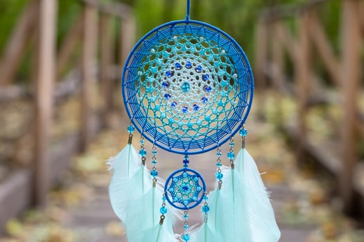 Handmade dream catcher with feathers threads and beads rope hanging photo