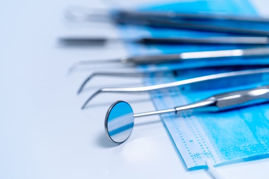 Dental treatment concept. Metal stomatology instruments. Closeup. photo