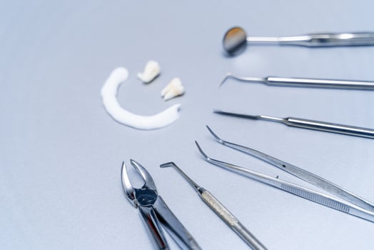 Denture and dental instruments. Individual dental treatment. Metal stomatology instruments. photo