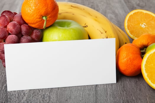 Card and White Paper Mockup Harmonized with Fresh Fruit, Crafting a Visual Symphony of Artful Design and Culinary Delight, Where Wholesome Ingredients Merge in a Feast of Vibrant Imagery photo