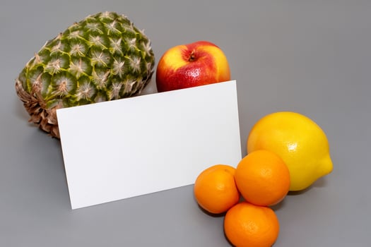 Card and White Paper Mockup Harmonized with Fresh Fruit, Crafting a Visual Symphony of Artful Design and Culinary Delight, Where Wholesome Ingredients Merge in a Feast of Vibrant Imagery photo